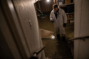 Flooded basement with several inches of standing water before cleanup - South Jordan, UT