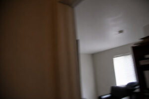 repaired ceiling visible in background of room during casual walk past
