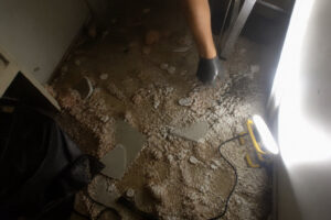 repaired ceiling visible in background of room during casual walk past