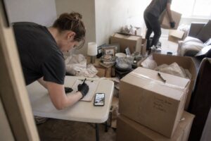 technician documenting household items during contents pack out after water damage in Utah home