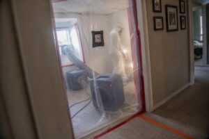 hepa air scrubbers running inside containment barrier during mold remediation with negative air pressure system