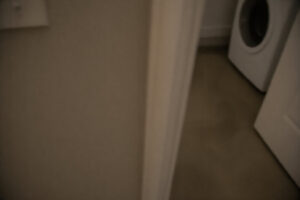 partial view of laundry room after water overflow taken while walking past